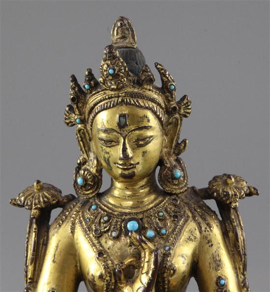 A Tibetan gilt copper alloy figure of Green Tara, 14th-15th century, height 21.3cm